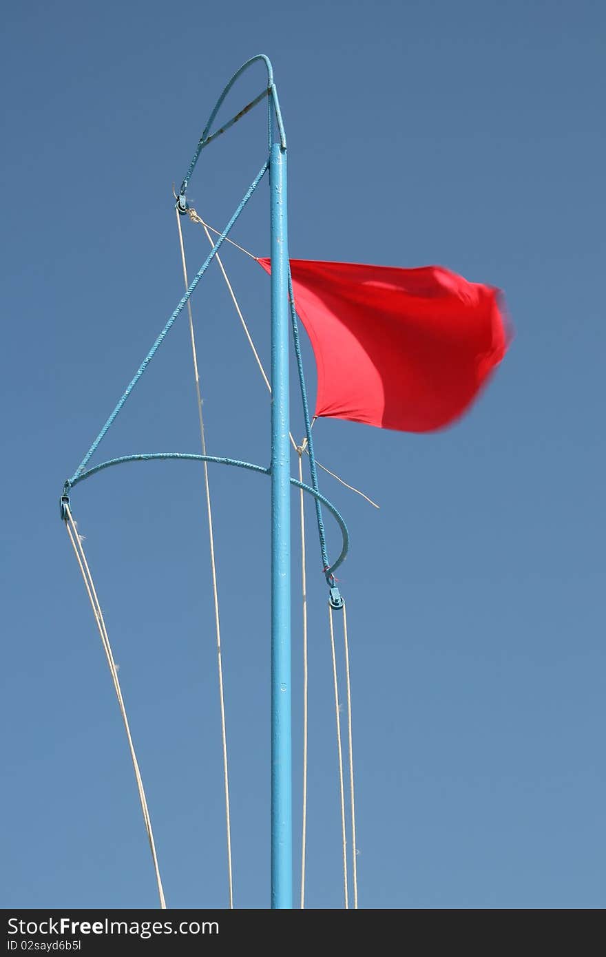 Red flag of danger at seaside