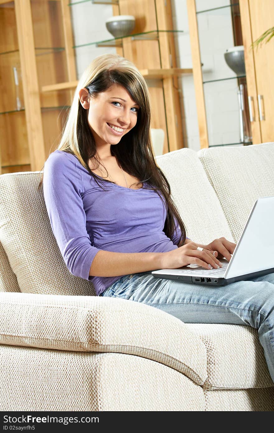 Woman in living room with a laptop. Woman in living room with a laptop