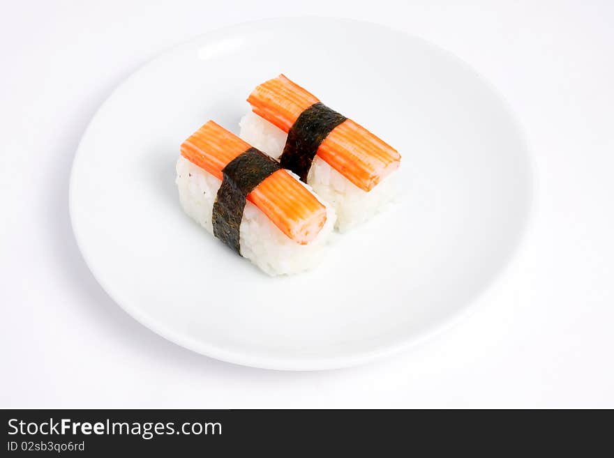 Japanese sushi with Kani and Seaweed on white background. Japanese sushi with Kani and Seaweed on white background