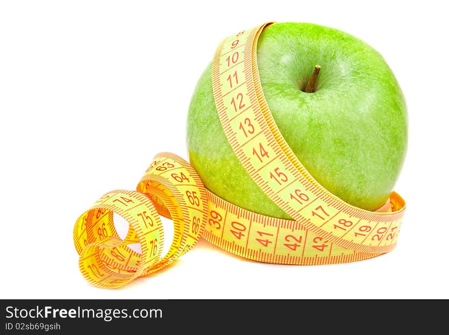 Green apple and tape measure isolated on white