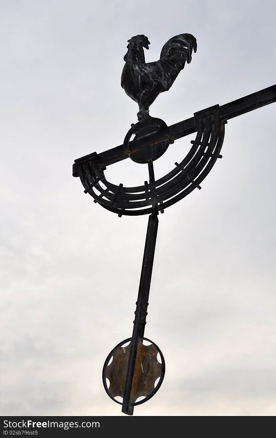 Silhouette of a rooster with pendulum