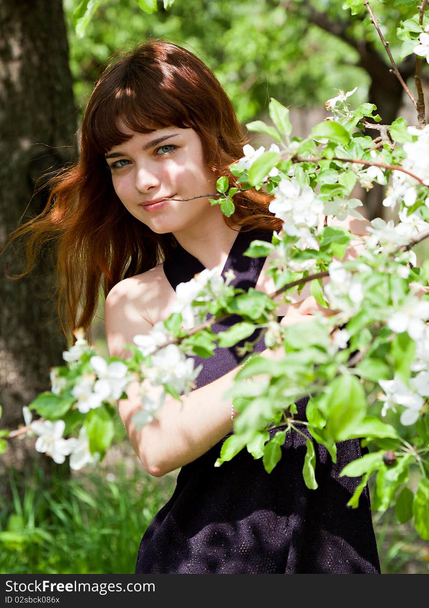 Beautiful girl in blossom orchard