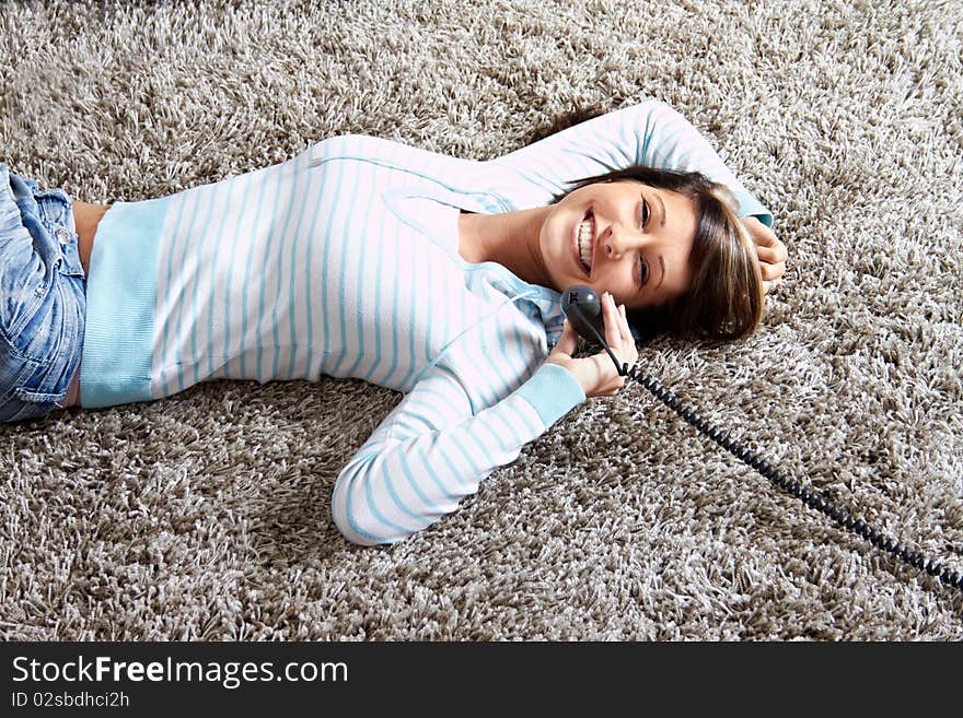 Woman in living room with a phone is calling. Woman in living room with a phone is calling