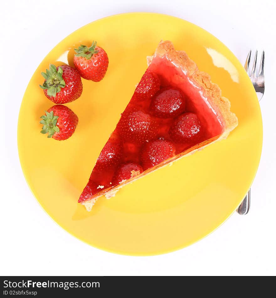 Piece of Strawberry Tart on a yellow plate decorated with strawberries, and a fork