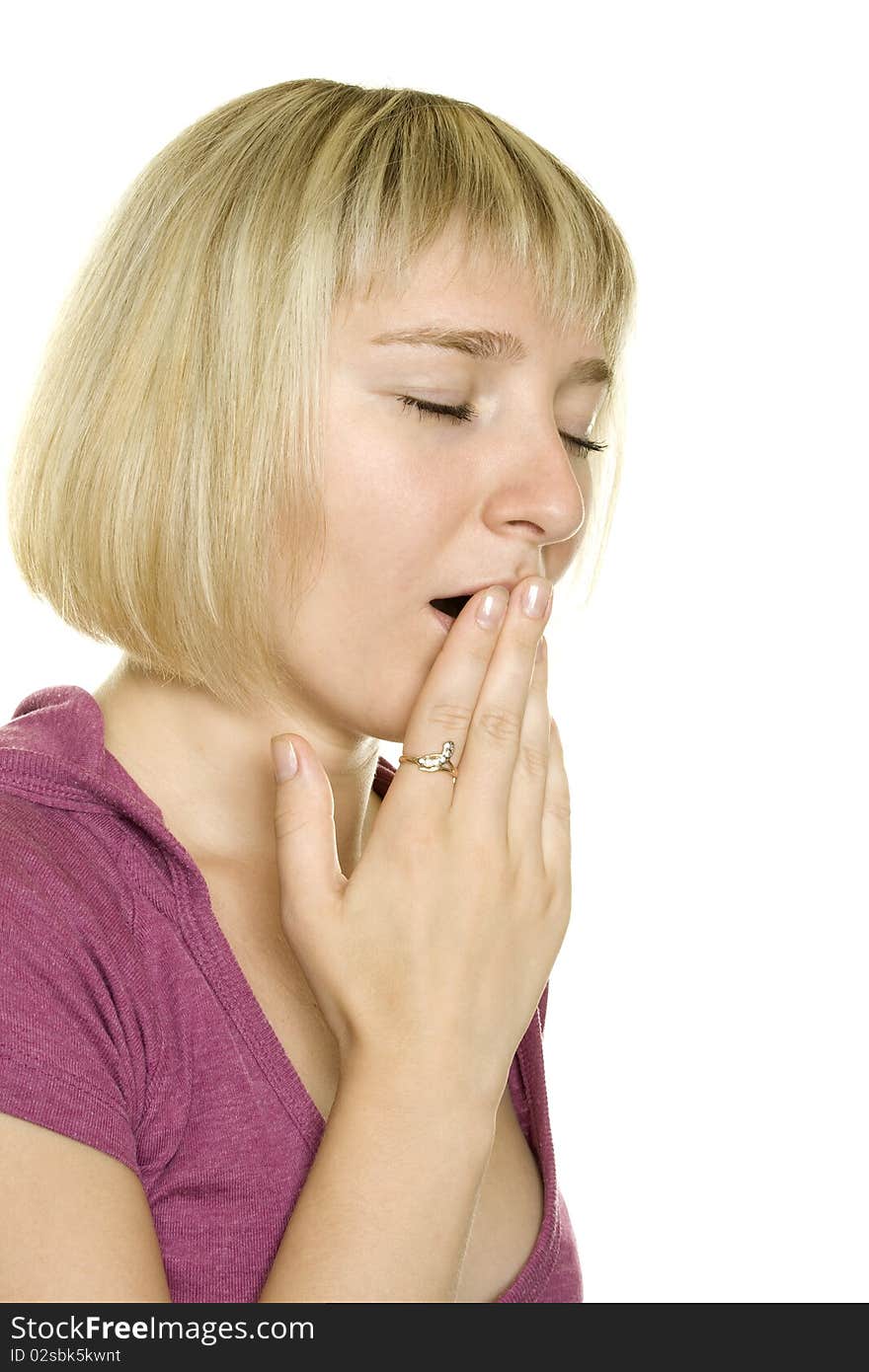 Girl yawns and covers her mouth with his hand. Isolated on white background