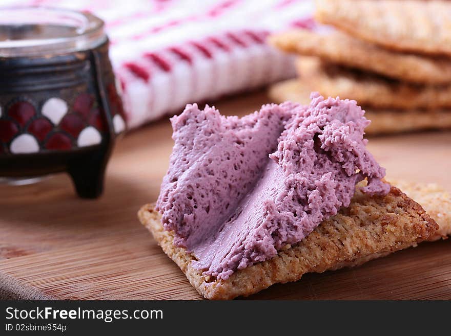 Wheat crackers on a kitchen board with whipped cream. Wheat crackers on a kitchen board with whipped cream.