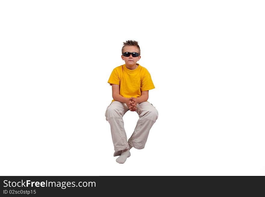 Boy with sunglasses sit in air, isolated on white background