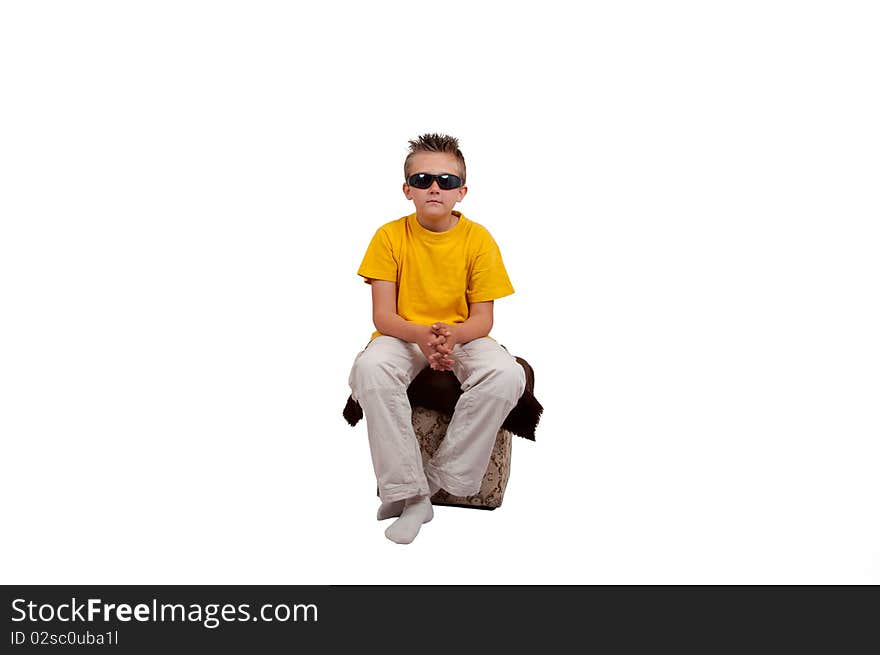 Boy with sunglasses sit on cube, isolated on white background