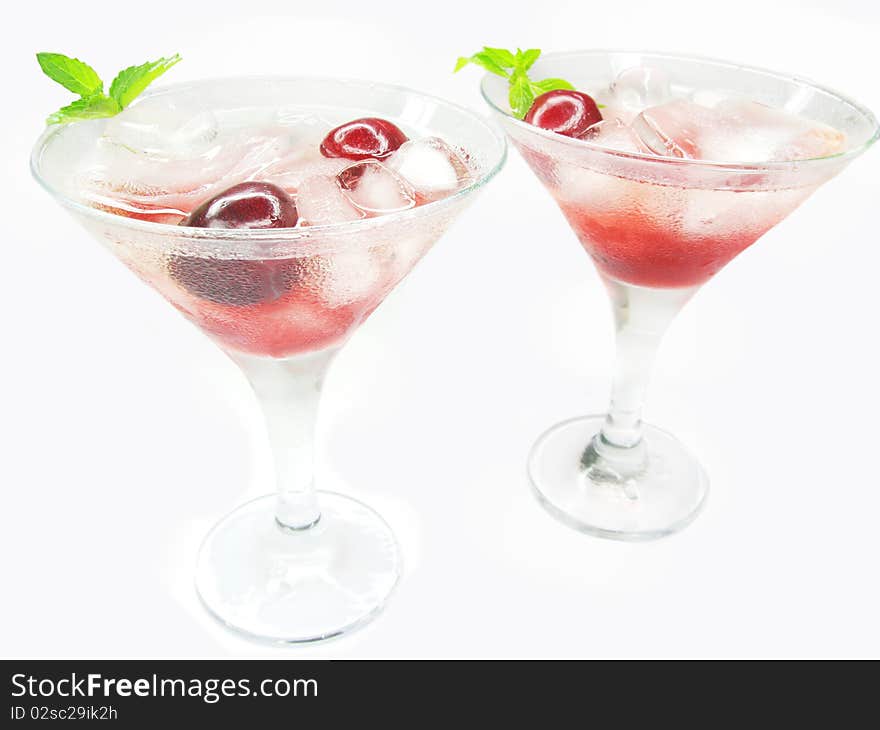 Alcohol red liqueur cocktail with ice and cherry two glasses. Alcohol red liqueur cocktail with ice and cherry two glasses