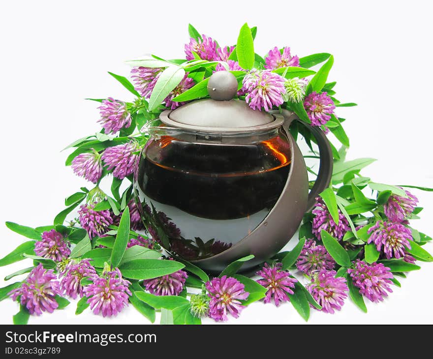 Floral summer tea in teapot among pink flowers. Floral summer tea in teapot among pink flowers