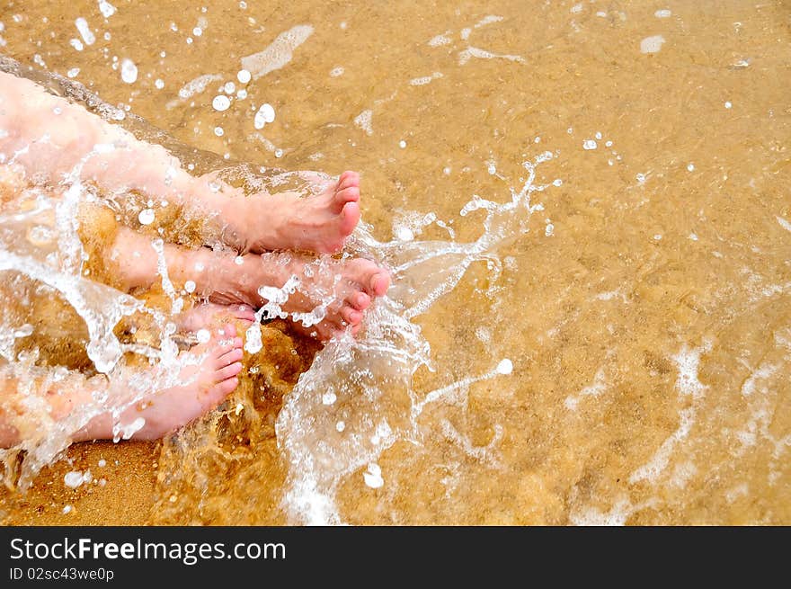 Mother and son playing water at the beach. Mother and son playing water at the beach.