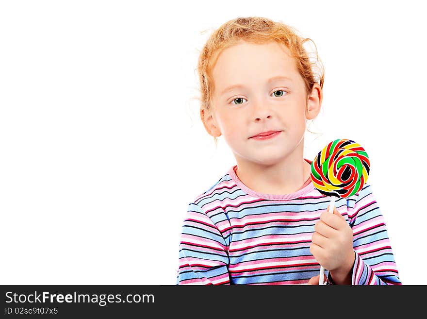 Portrait of a little red-haired girl licking lollipop. Isolated over white background. Portrait of a little red-haired girl licking lollipop. Isolated over white background.