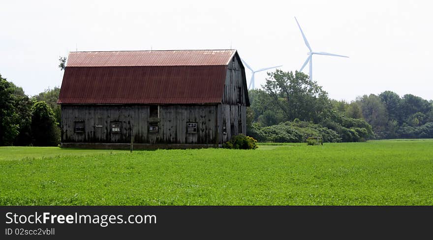 Modern Windmills in the background of farm land. Modern Windmills in the background of farm land.