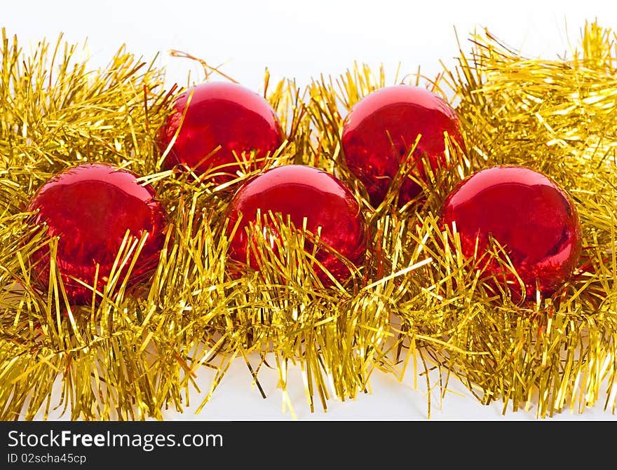 Red christmas balls on gold tinsel