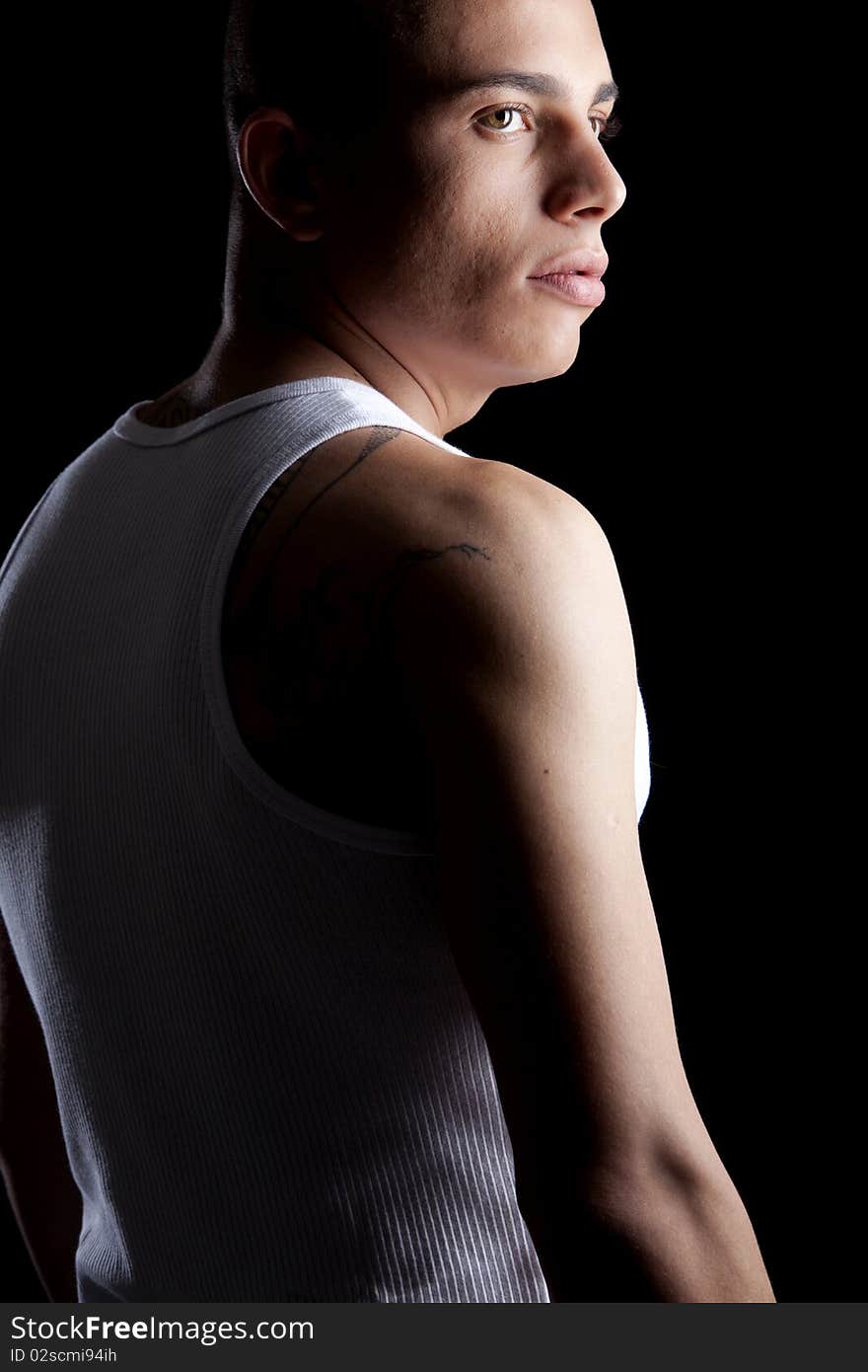 A good looking, muscular built, man on a black background. A good looking, muscular built, man on a black background.