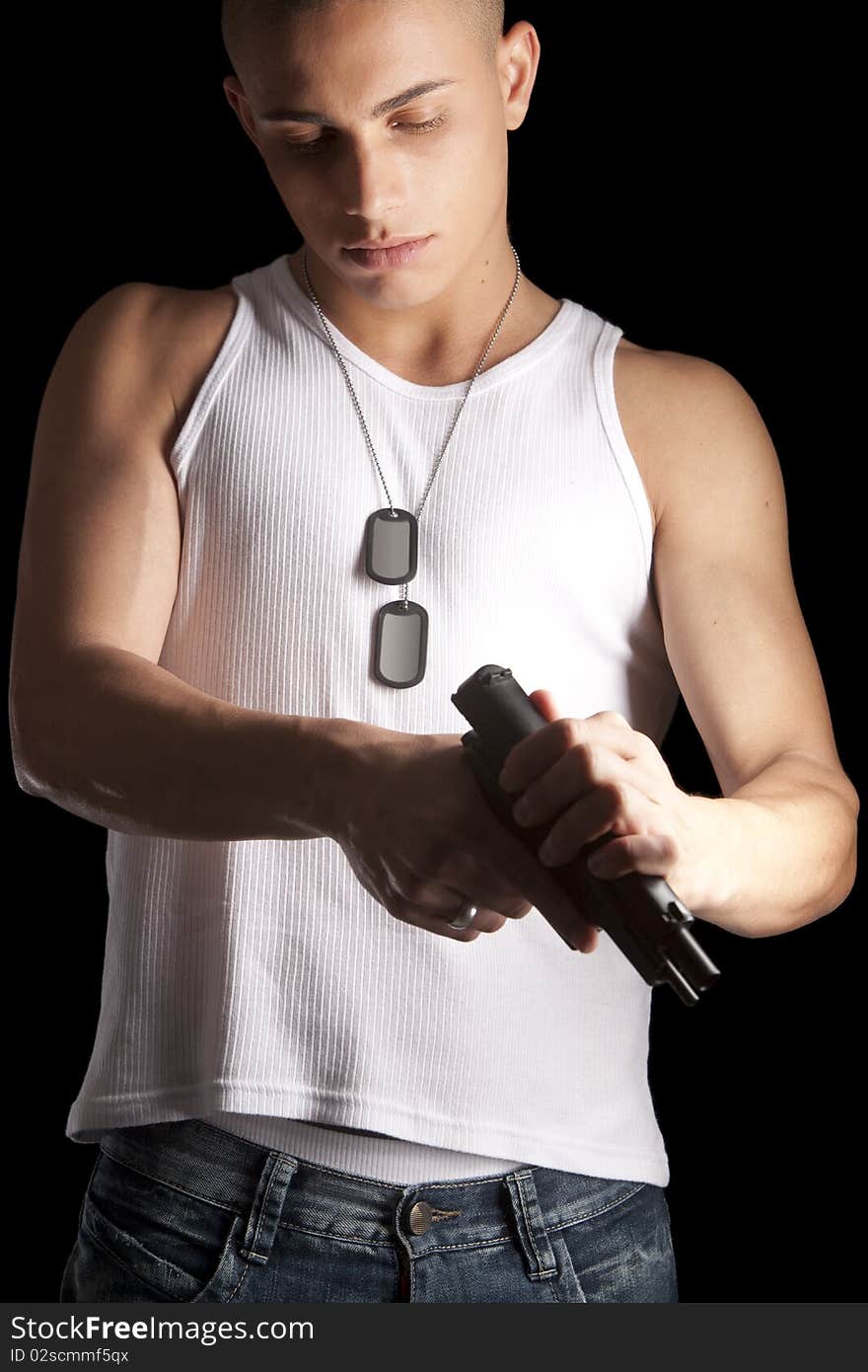 A good looking, muscular built, man on a black background with dog tags. A good looking, muscular built, man on a black background with dog tags.