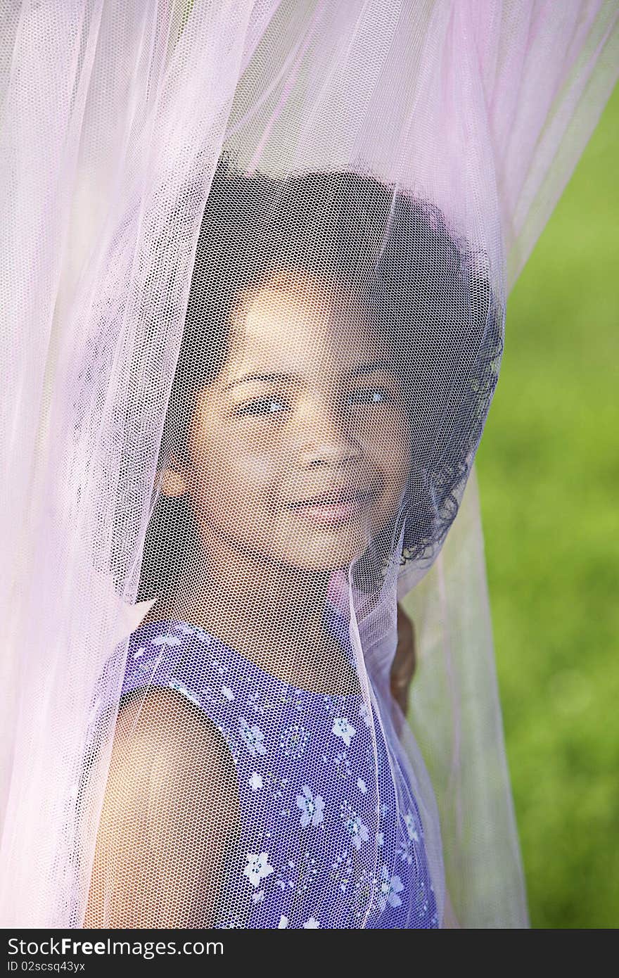 Girl posing behind canopy