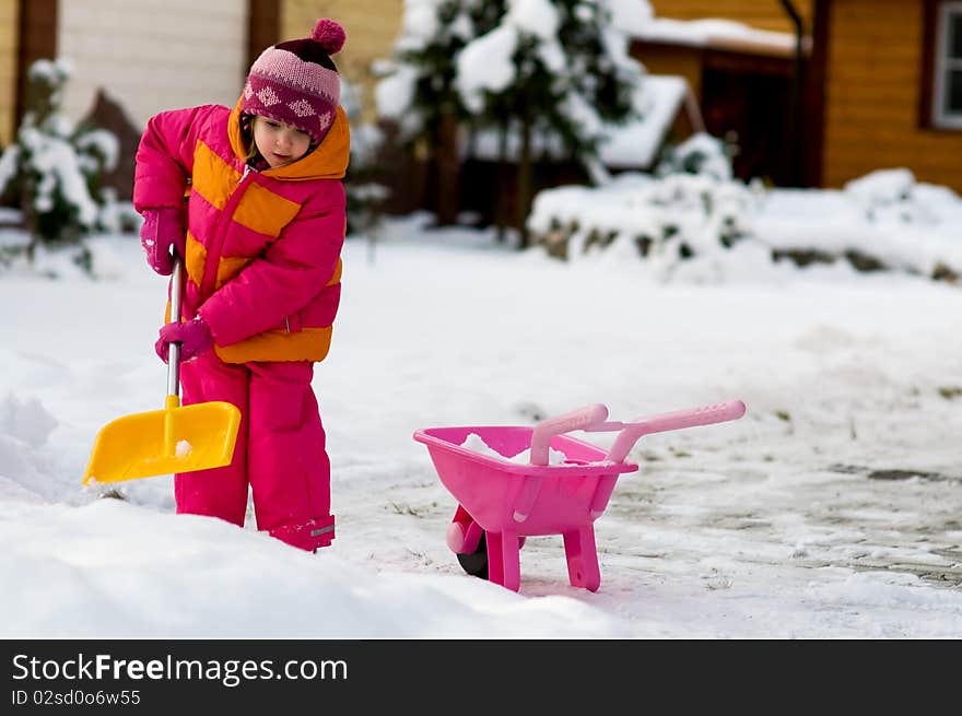 Nice little girl playing with snow