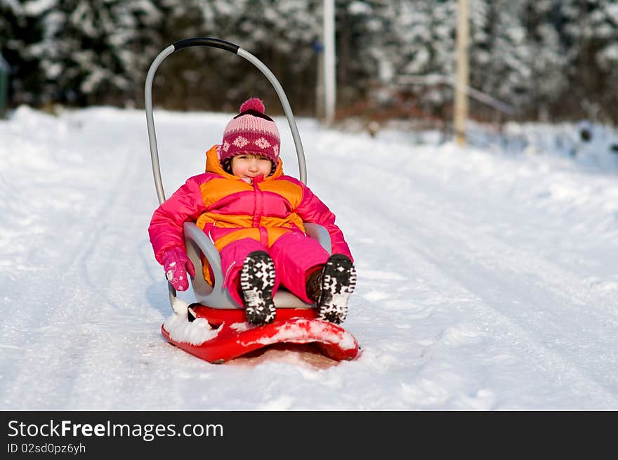 Nice Toddler Girl In Winter Pink Hat On Sleigh