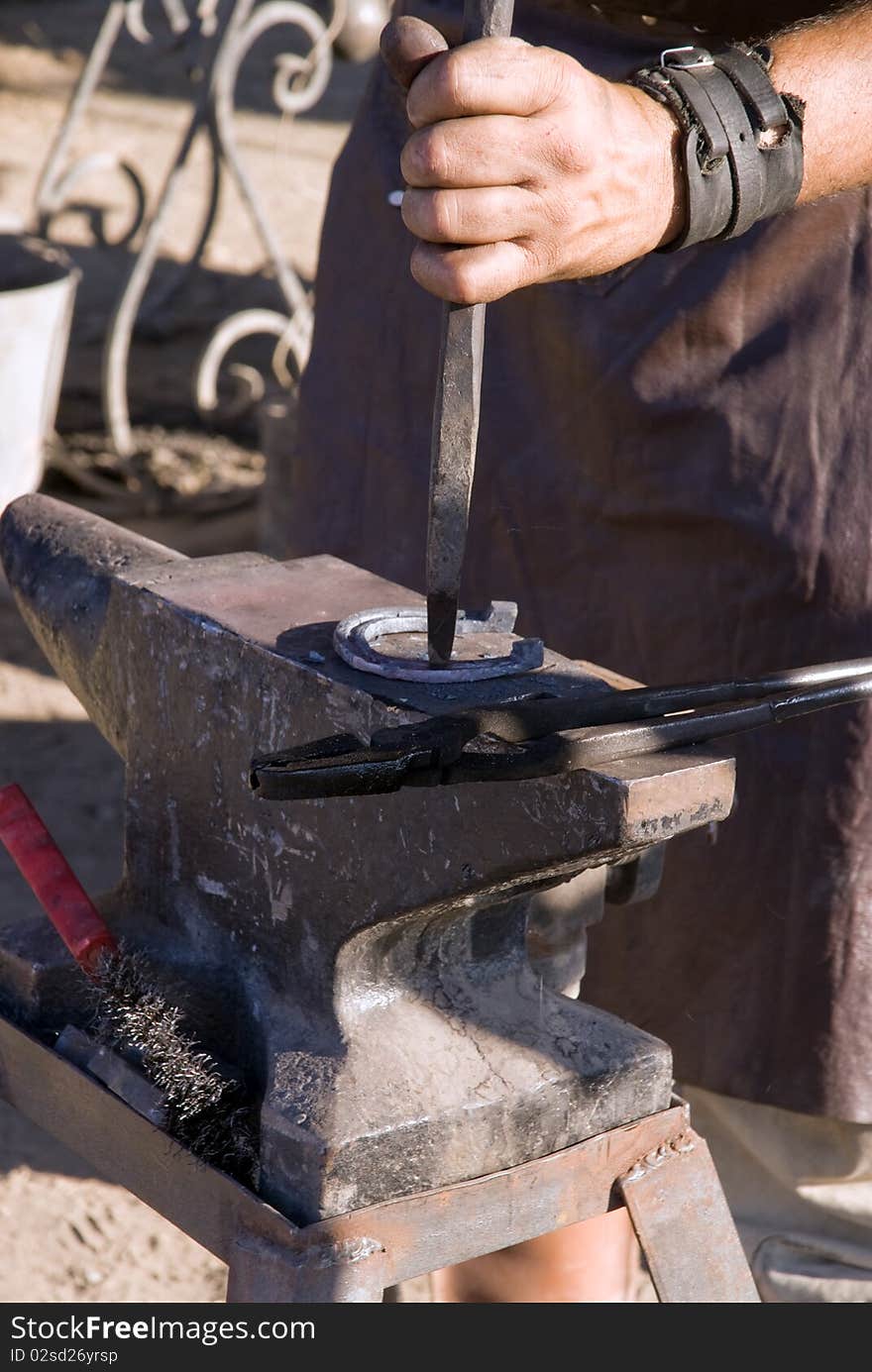 Farrier is making the horseshoe