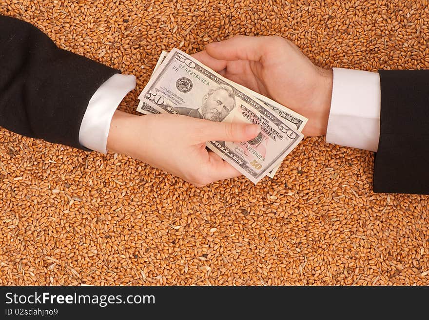 The businessman pays delivery of wheat by dollars. The businessman pays delivery of wheat by dollars