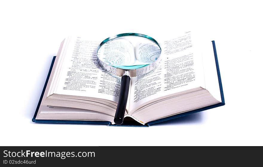 An opened book on a white background and magnifying glass on it