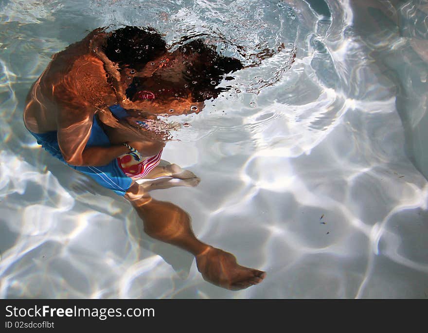 A couple share an intimate kiss underwater. A couple share an intimate kiss underwater