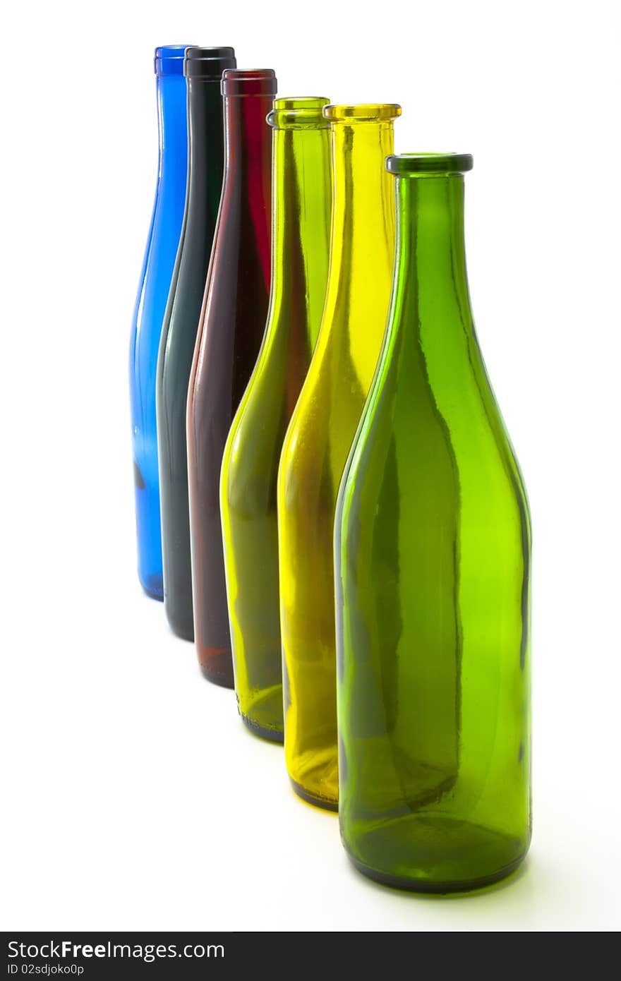 A collection of colorful glass wine bottles arranged in a line. A collection of colorful glass wine bottles arranged in a line.