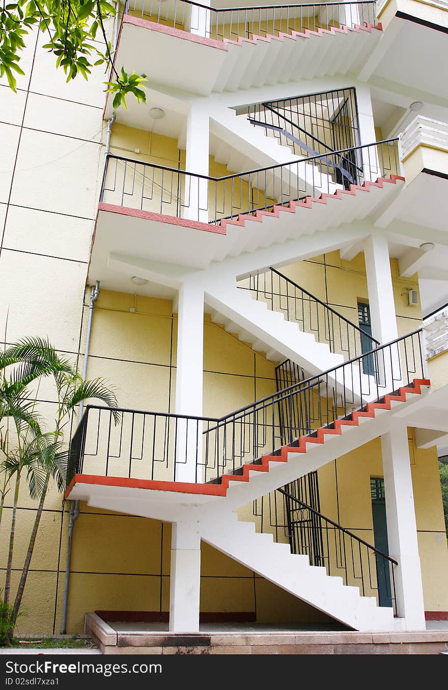 Closeup of concrete stairway with brick stairs and stucco walls