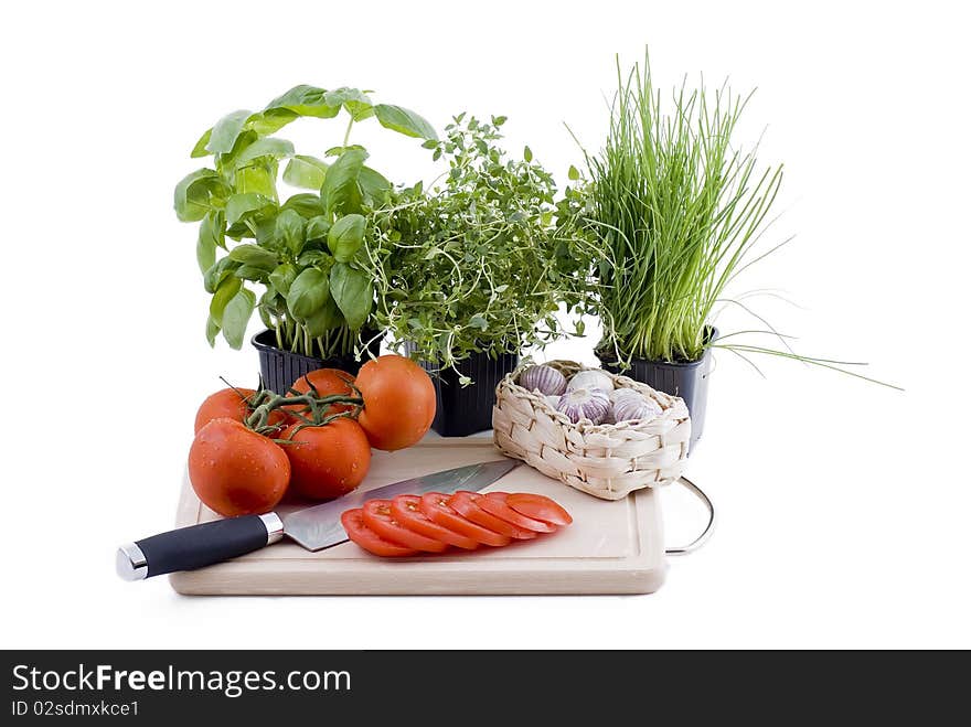 Herbs With Chopping Board Of Tomato And Garlic