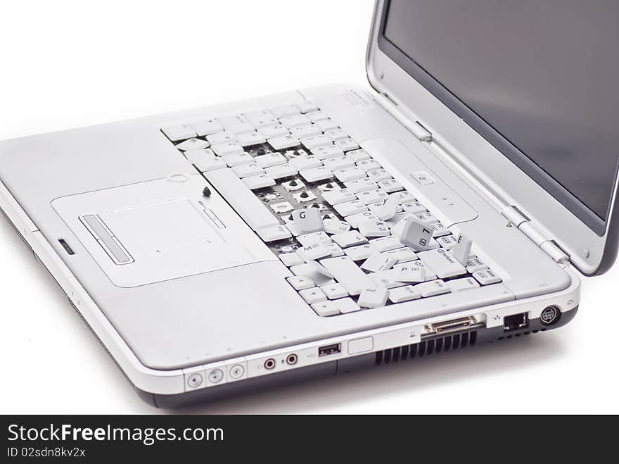 Damged laptop keyboard with teared out keys. Damged laptop keyboard with teared out keys