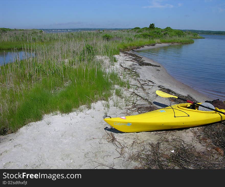 Sunshine yellow kayak on the beach