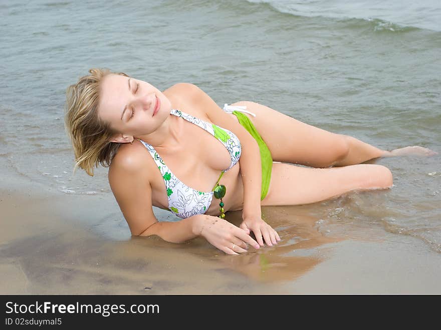 girl sitting on the beach. girl sitting on the beach