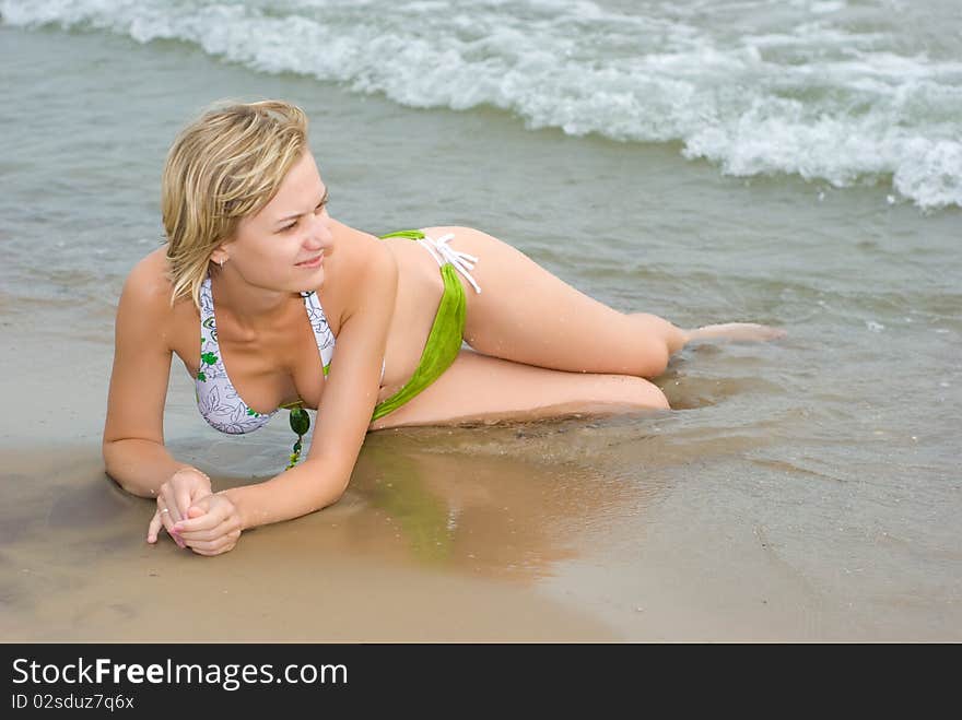 Sitting on the beach in water