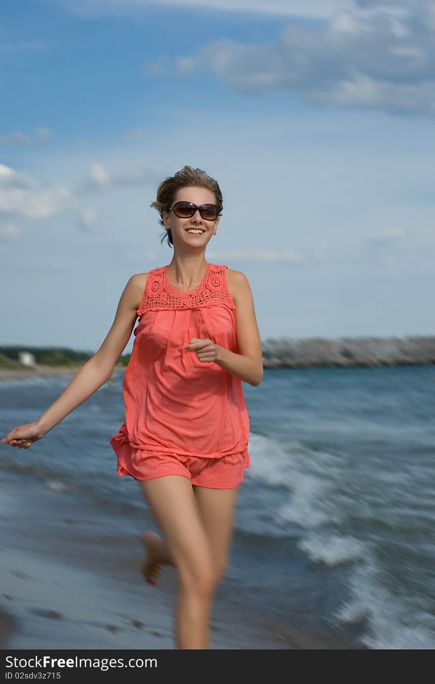 Young woman running on the beach