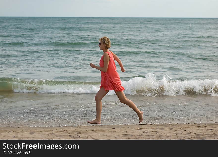 Young woman running on the beach