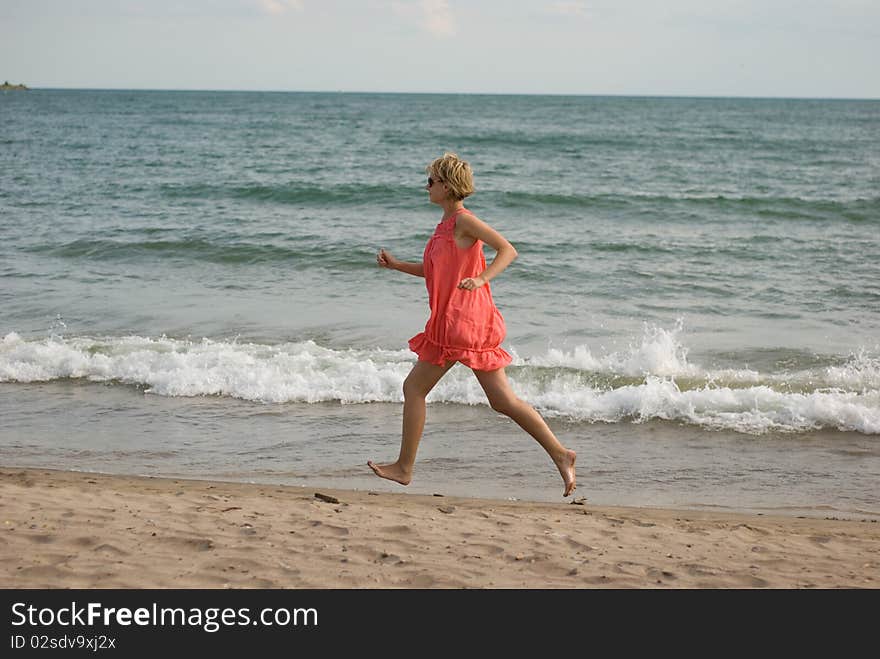 Young woman running on the beach