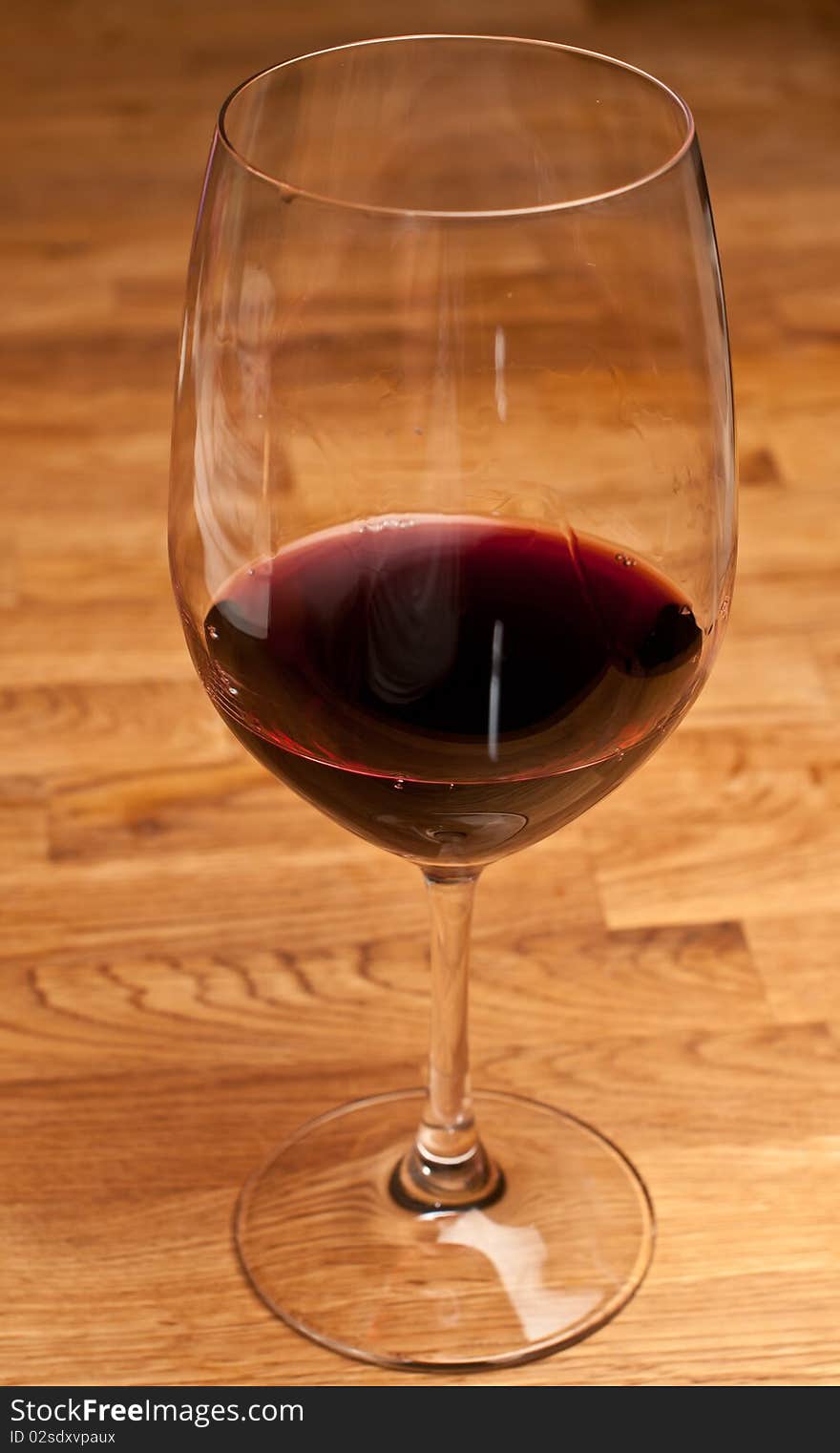 Glass of red wine on a wood table