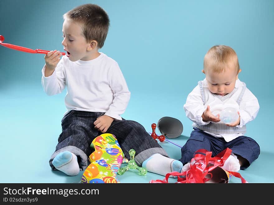 Beautiful caucasian kids playing with toys in studio. Beautiful caucasian kids playing with toys in studio