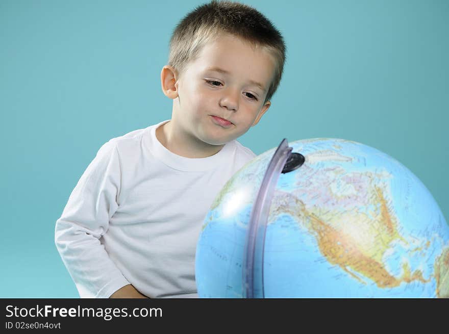 White boy learning geography with globe