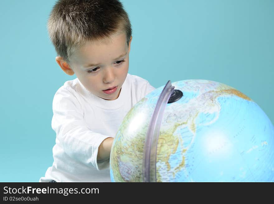 White boy learning geography with globe