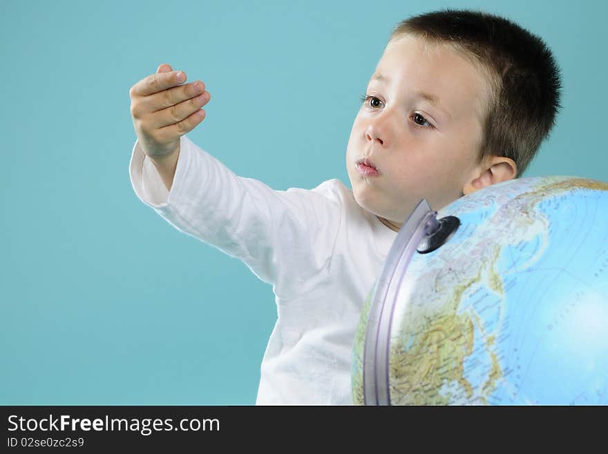 Caucasian child evaluating destinations on globe