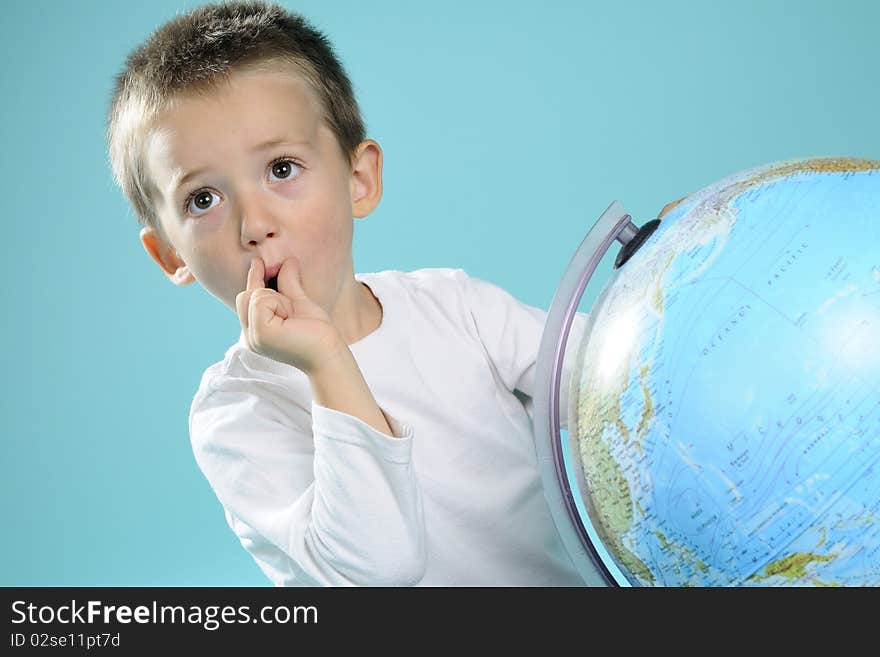 One child evaluating destinations on globe