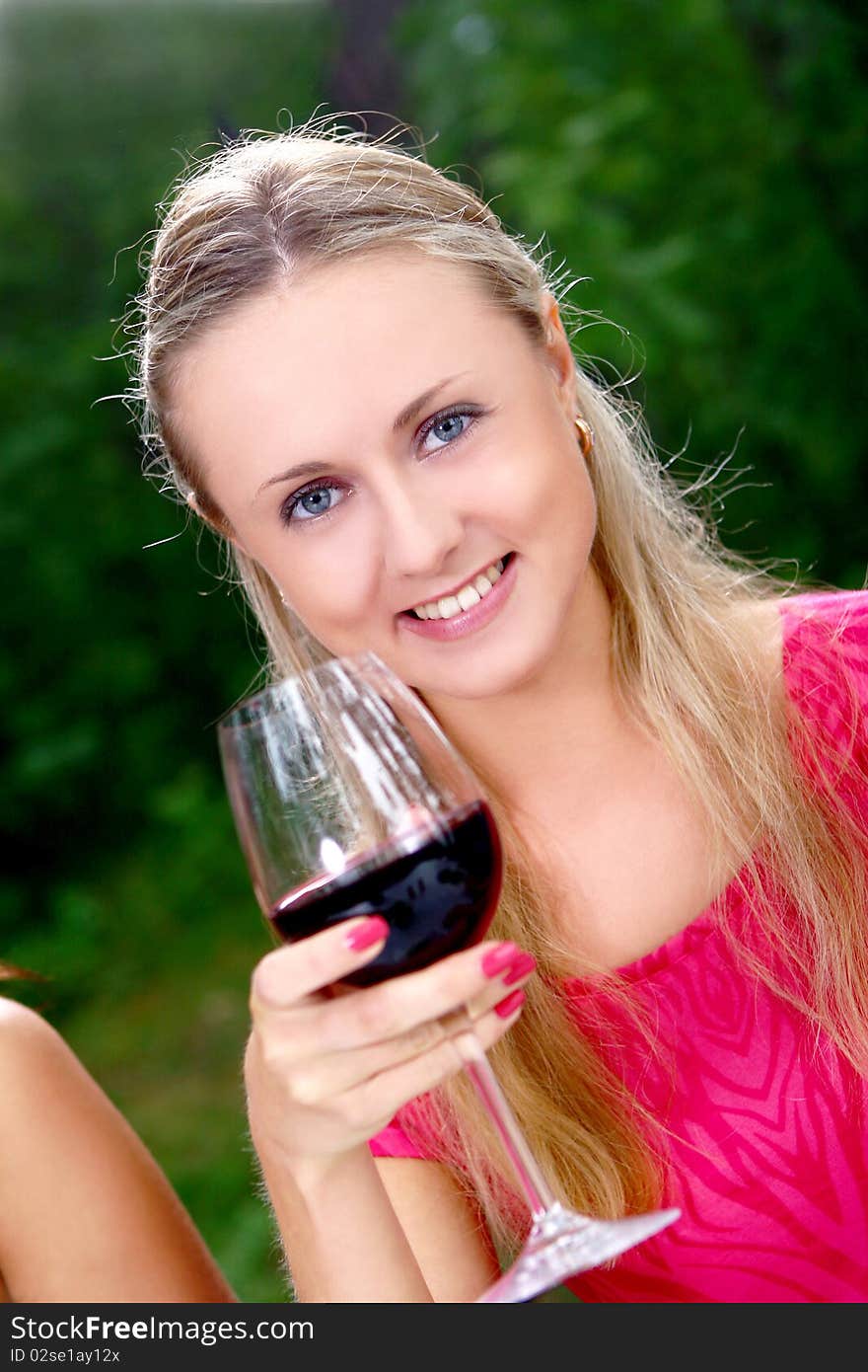 Group of beautiful girls drinking wine in the park