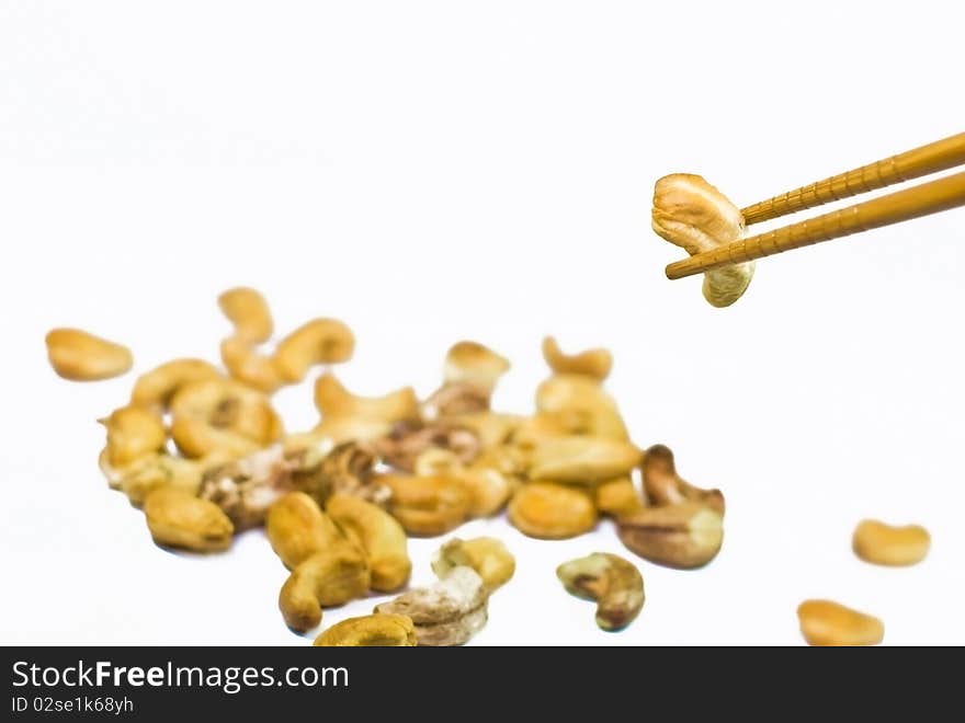 Cashew nut on chopstick