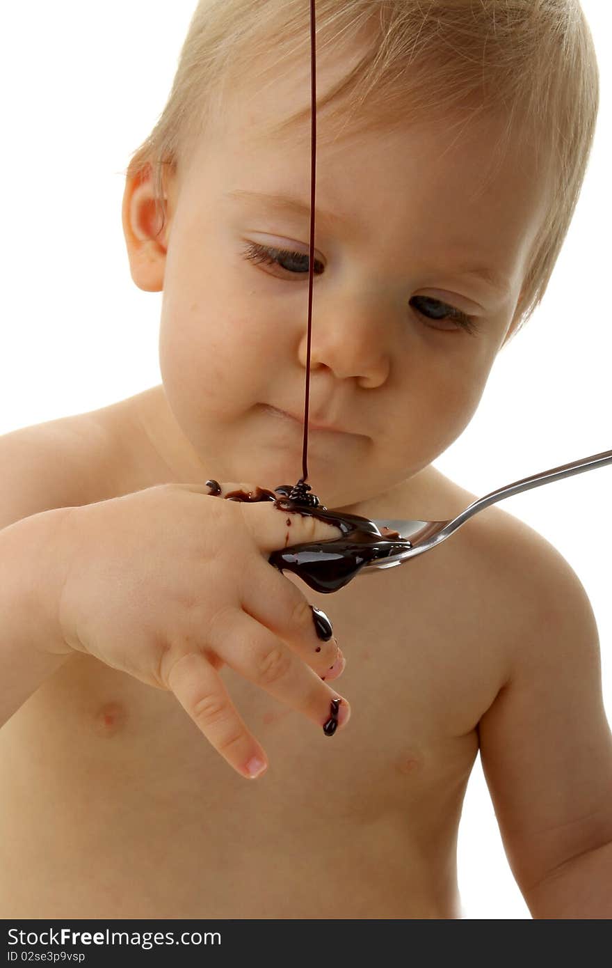 Baby playing with chocolate on white. Baby playing with chocolate on white