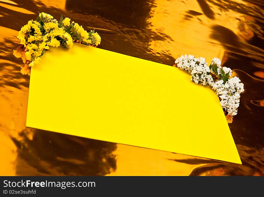 Yellow paper with flowers on yellow background. Yellow paper with flowers on yellow background