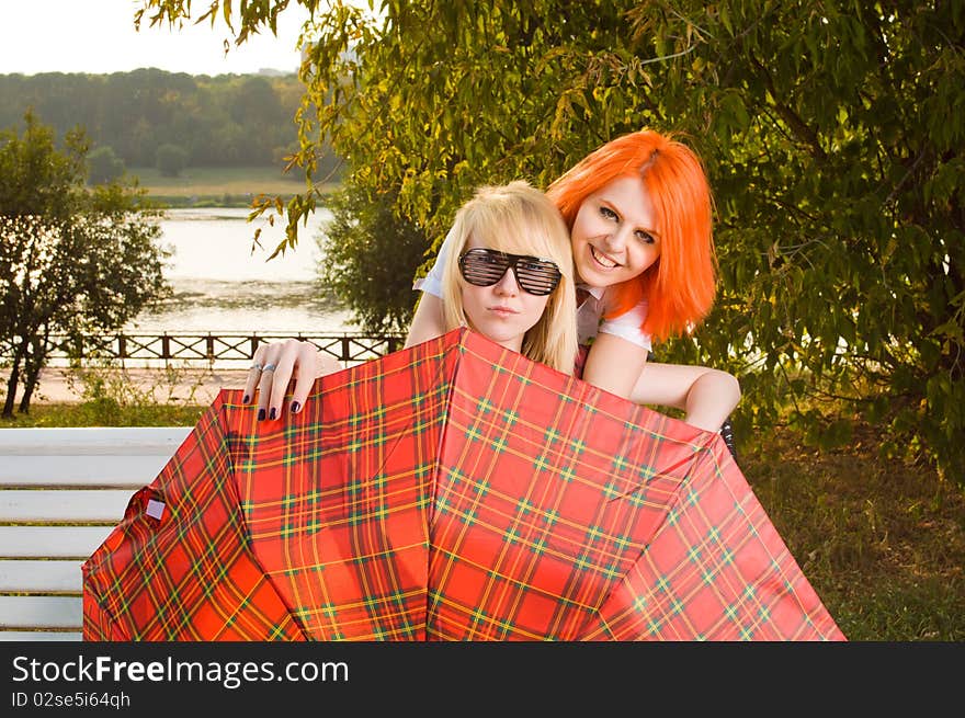 Two teenage girls have fun at the summer park. Two teenage girls have fun at the summer park