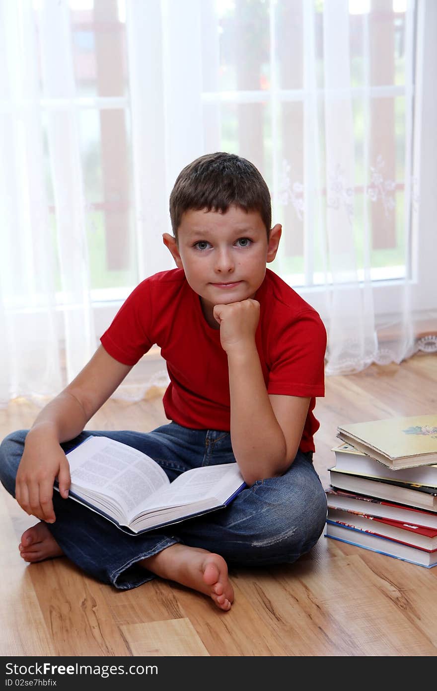 School boy lying and reading book. School boy lying and reading book.
