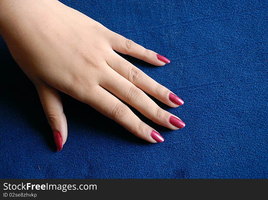 Woman hand on blue background.